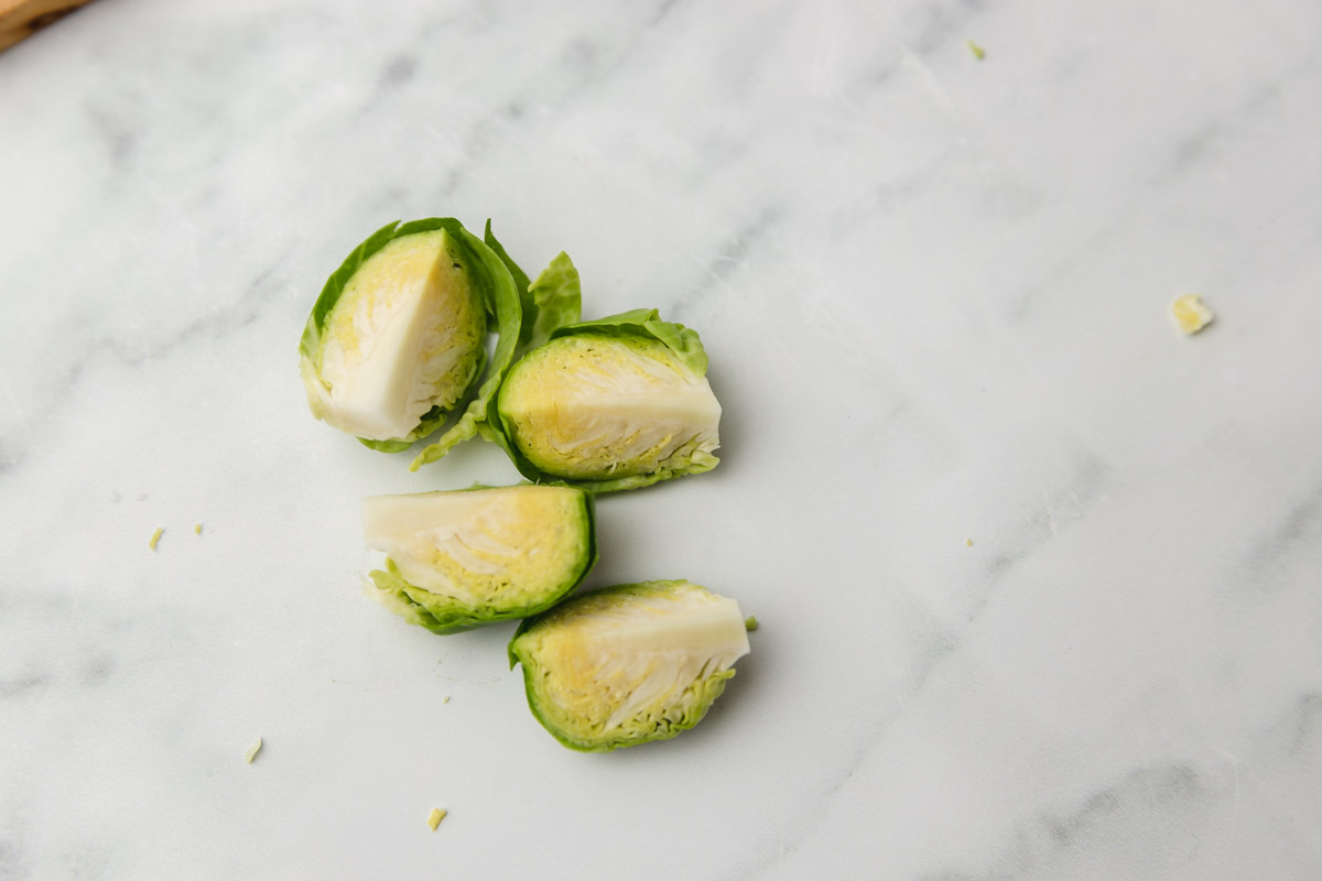 four Brussel sprouts wedges on a counter.
