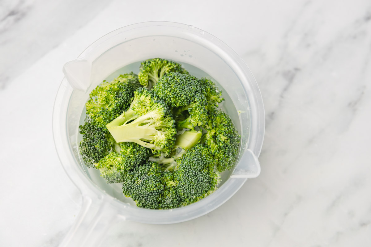 broccoli florets in a bowl of water.