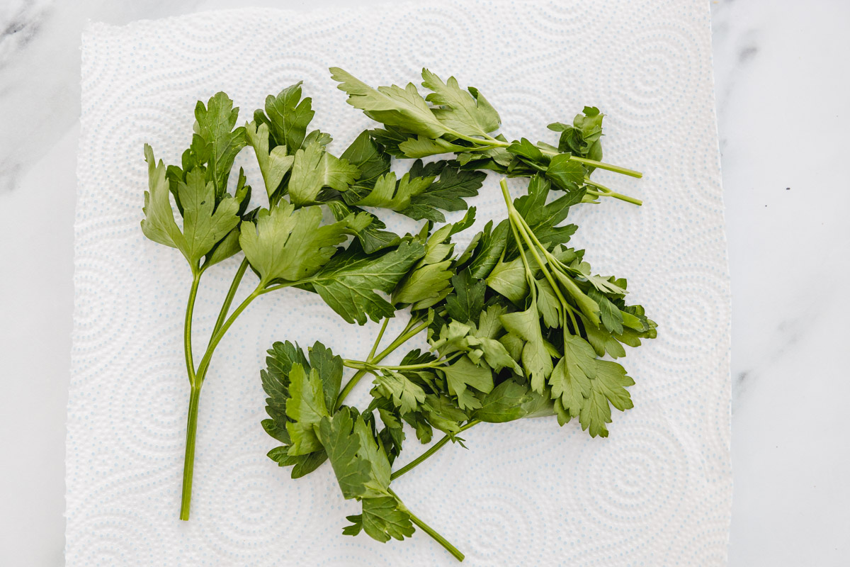 fresh parsley lined on a kitchen paper towel.